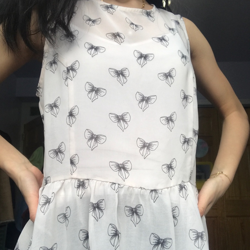 Sheer Blush Peplum Top with Black bows